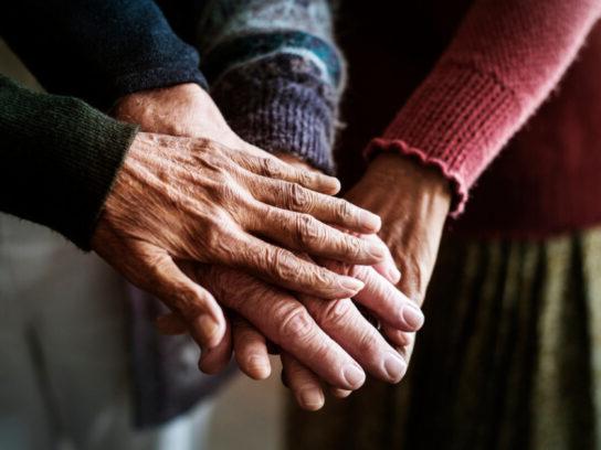 photo of closeup of hands of group of seniors